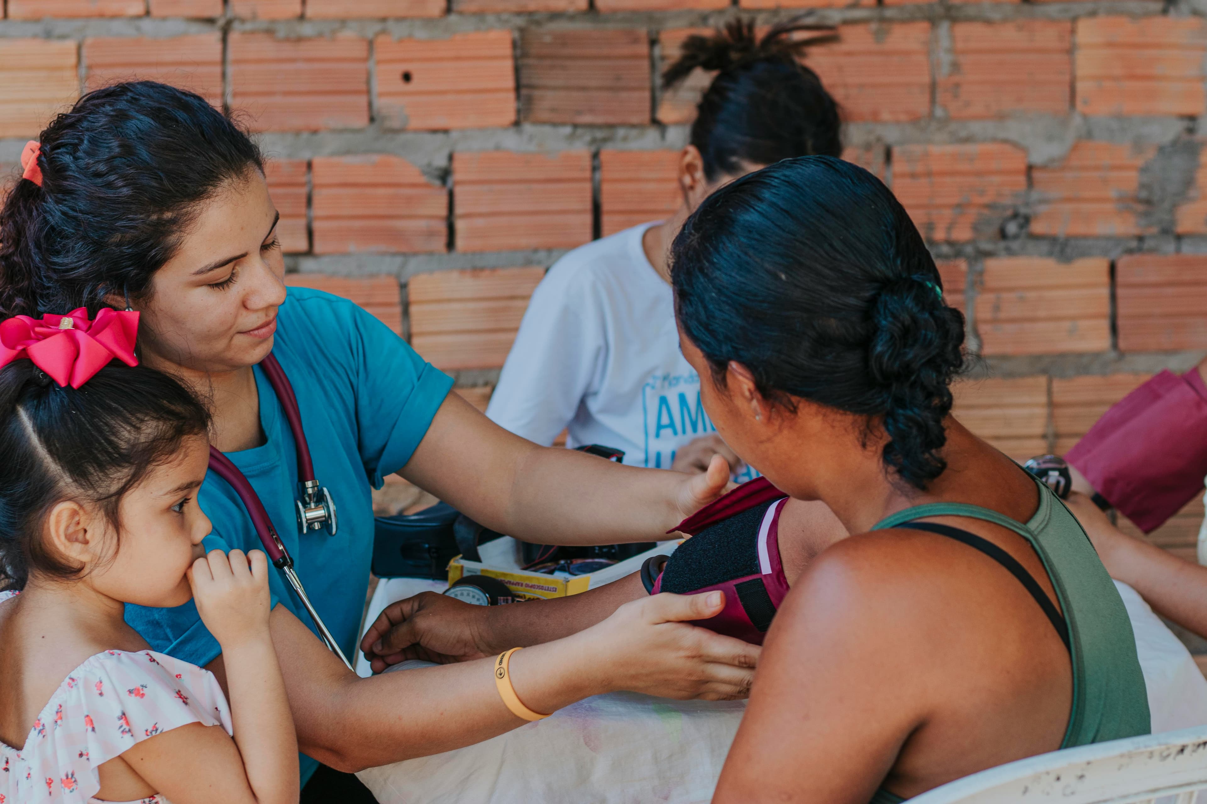 A clinician examines a young patient during a community clinic day
