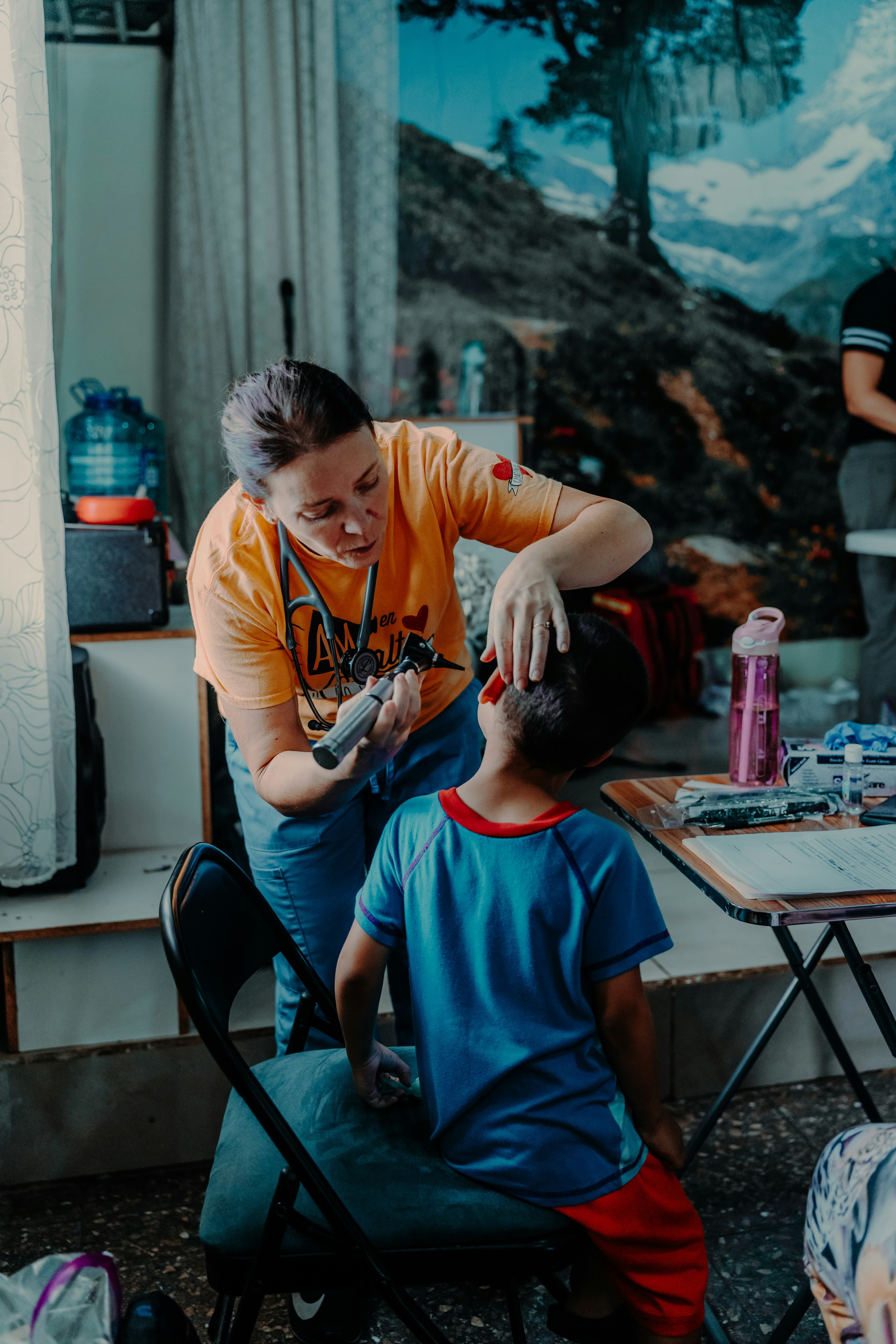 A clinical volunteer talks with a patient at a rural clinic
