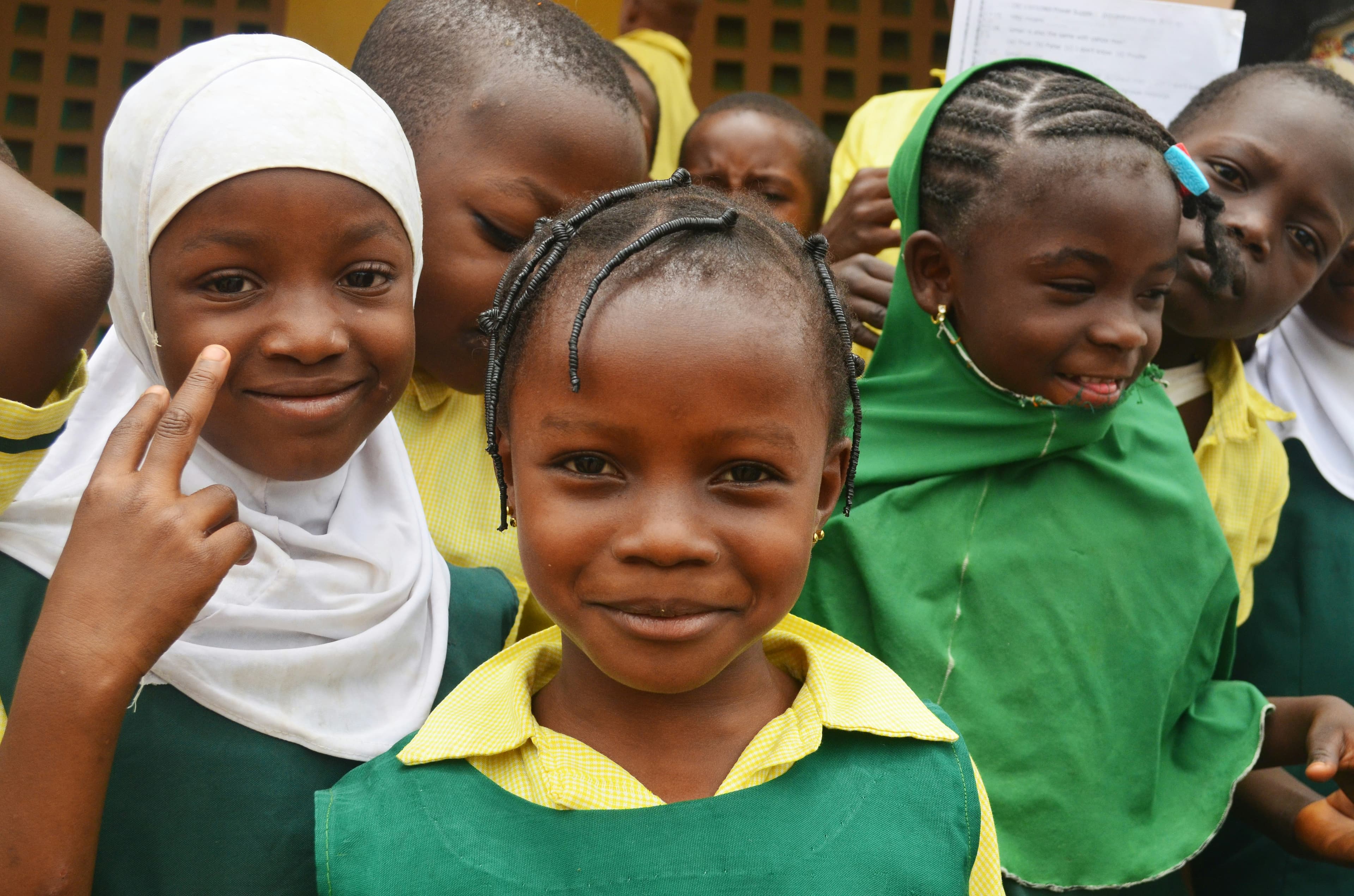 Schoolchildren smile during a health outreach visit