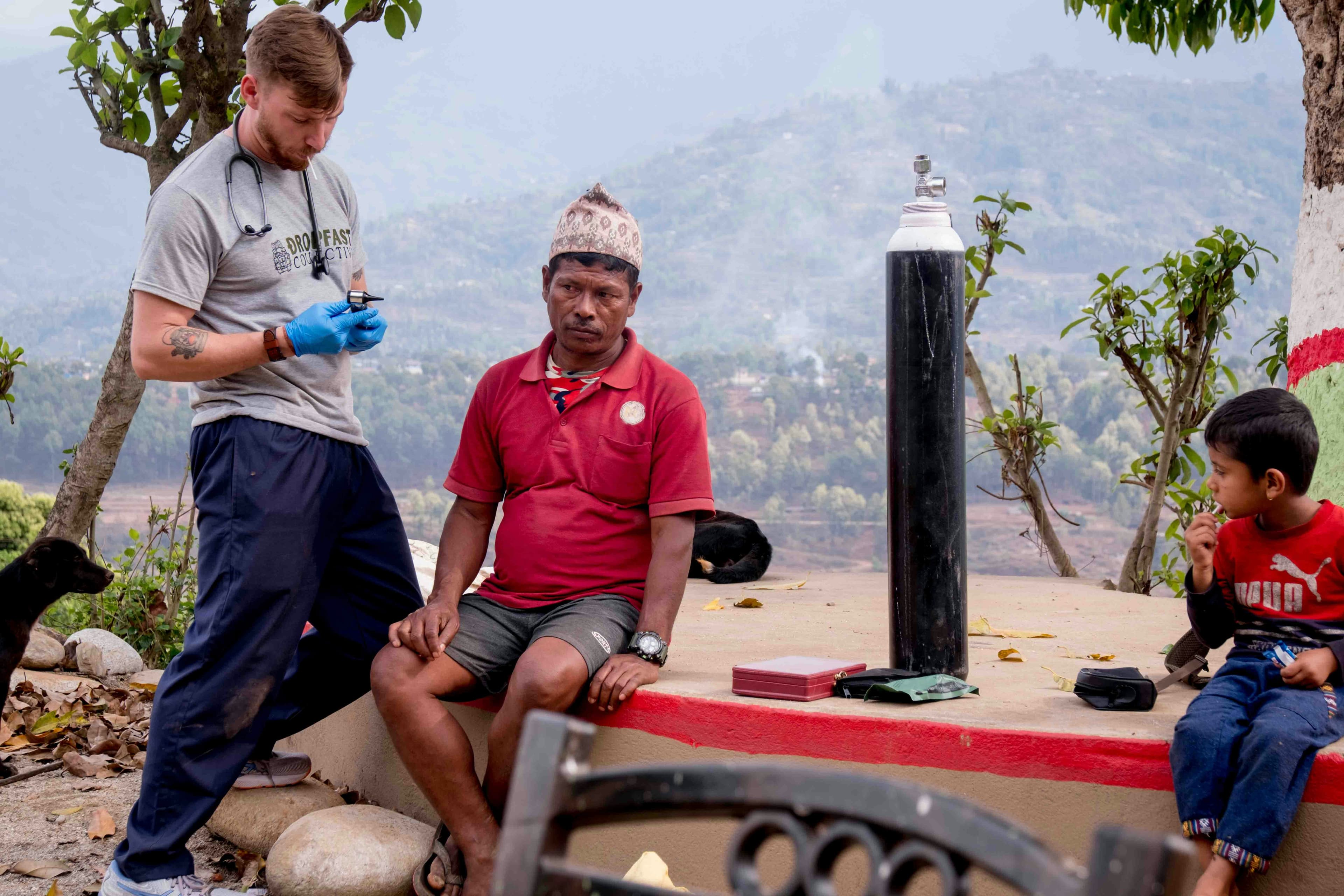 A mobile health team consults with villagers outdoors